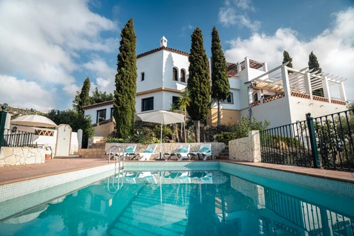 Restful day by a pool in a rental villa in Frigiliana. Andalusian holiday house with a swiming pool. Calm day by a pool after active cultural trip in Andalusia.